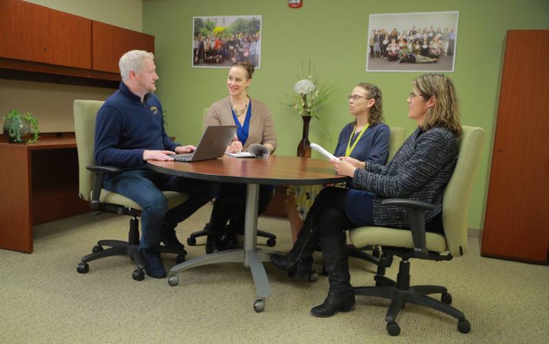 Group seated at a table in a conference room